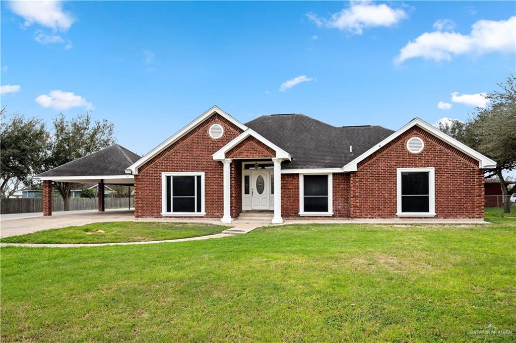 a front view of house with yard and green space
