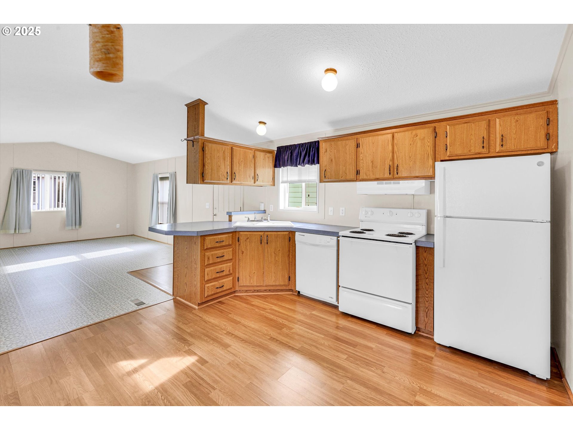 17655 Bluff Road, Unit 73 Sandy, OR 97055 - Photo 6 of 41 a kitchen with a refrigerator sink and cabinets