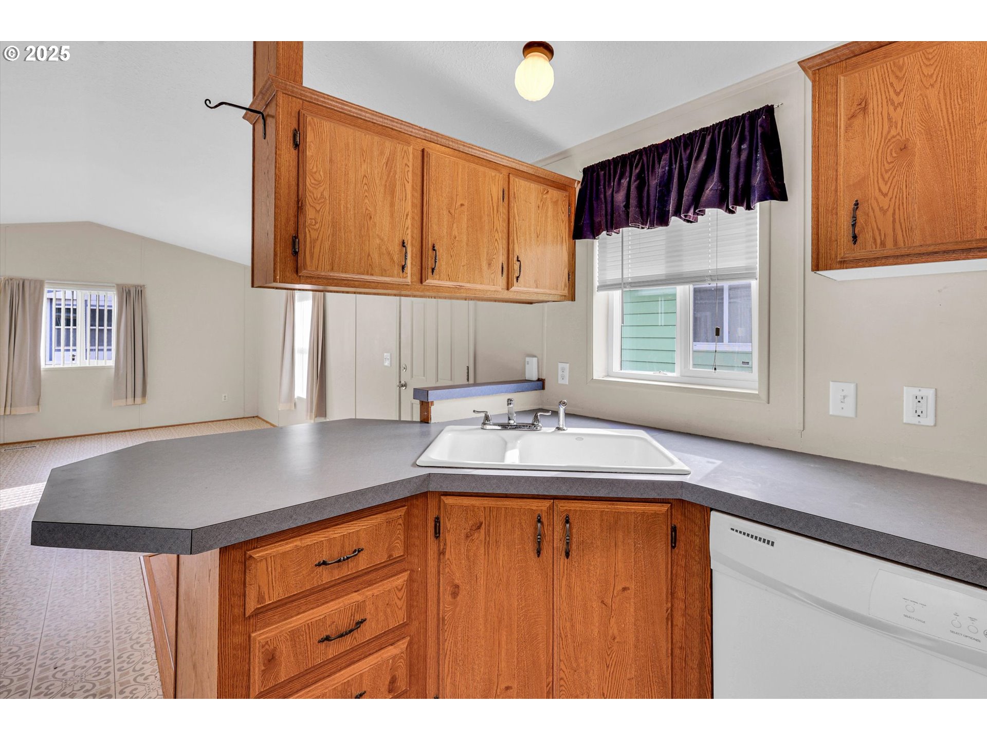17655 Bluff Road, Unit 73 Sandy, OR 97055 - Photo 7 of 41 a kitchen with a sink a window and cabinets