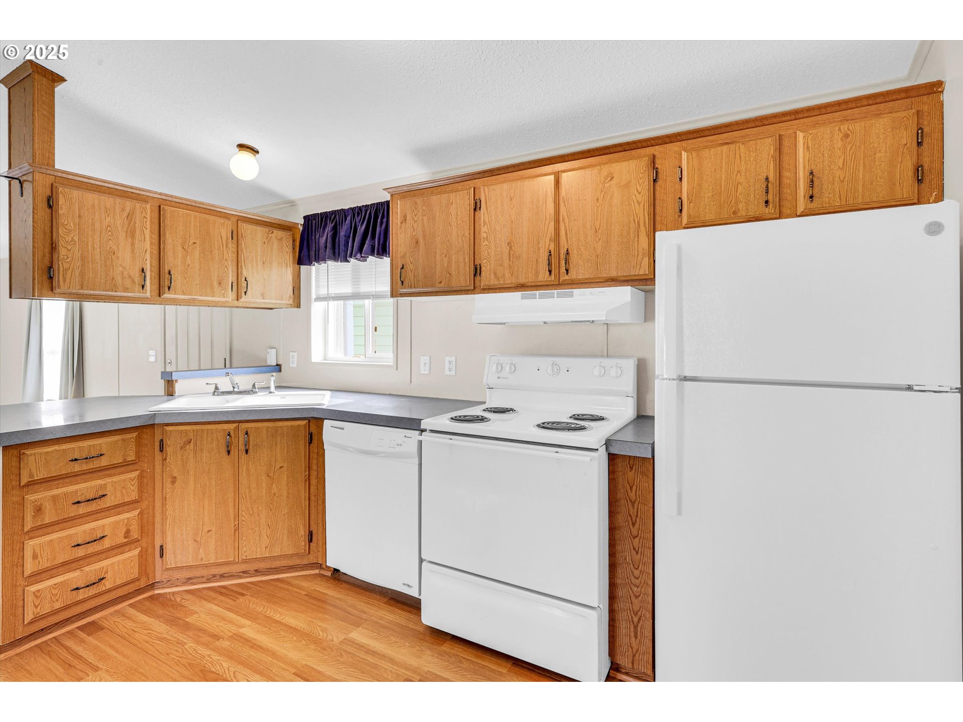 17655 Bluff Road, Unit 73 Sandy, OR 97055 - Photo 8 of 41 a kitchen with stainless steel appliances granite countertop a refrigerator sink stove and white cabinets