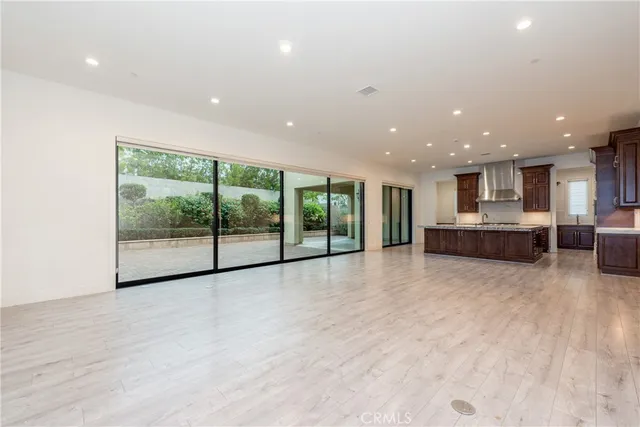 a view of an empty room with a kitchen
