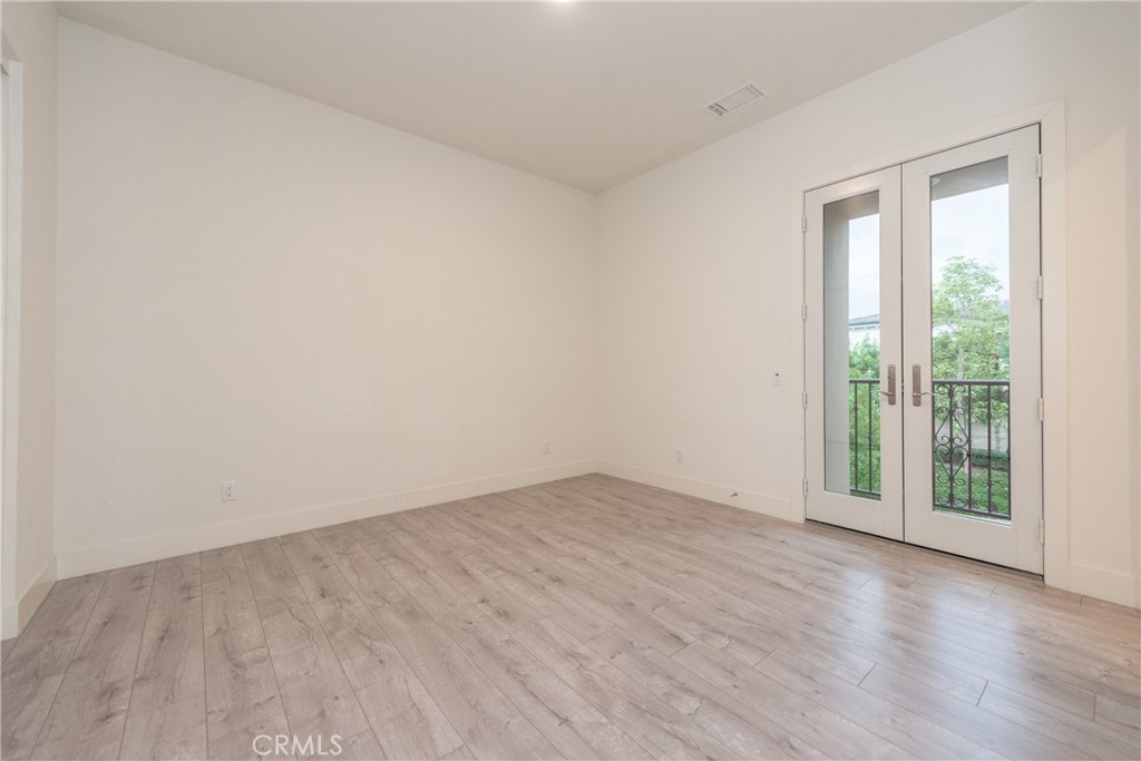 93 Spacial Irvine, CA 92618 - Photo 19 of 29 an empty room with wooden floor and windows