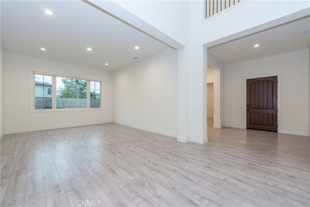 93 Spacial Irvine, CA 92618 - Photo 2 of 29 an empty room with wooden floor and windows