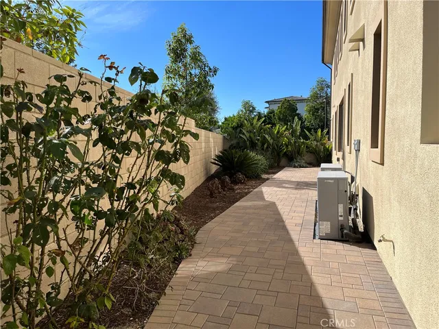 a view of a house with a yard and potted plants