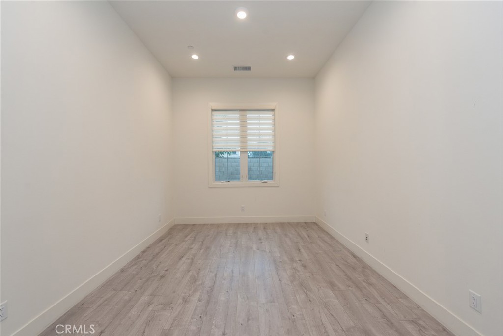93 Spacial Irvine, CA 92618 - Photo 5 of 29 an empty room with wooden floor and windows