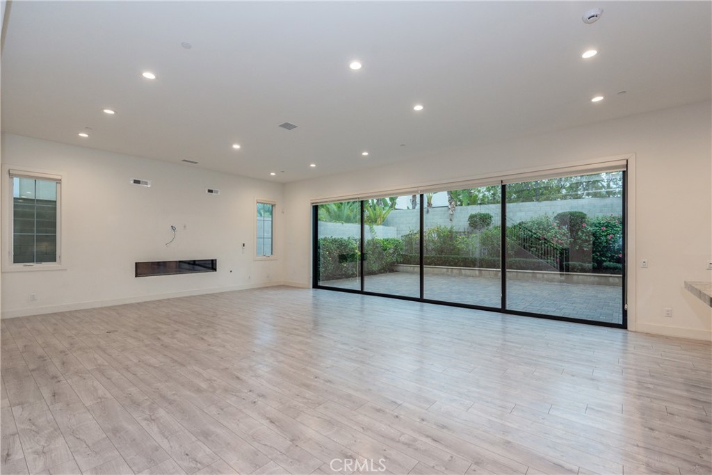 93 Spacial Irvine, CA 92618 - Photo 7 of 29 a view of an empty room with a sliding door