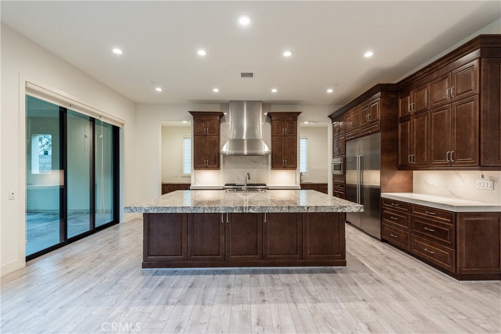 93 Spacial Irvine, CA 92618 - Photo 9 of 29 a large kitchen with stainless steel appliances granite countertop a stove and a wooden cabinets