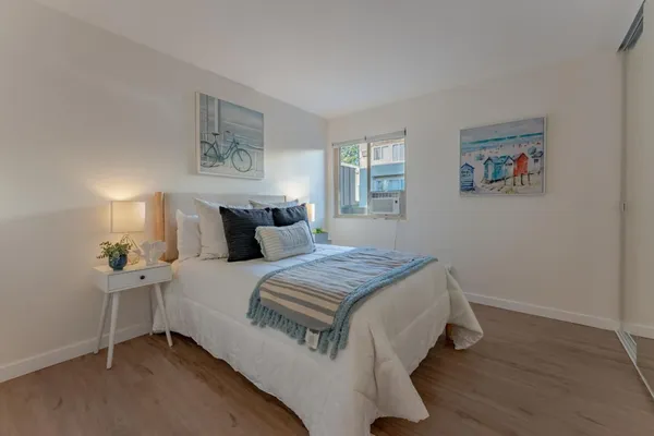 a bedroom with a bed and wooden floor