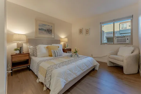 a bedroom with bed and window