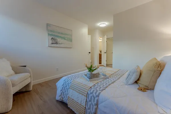 a bedroom with a bed and a couch