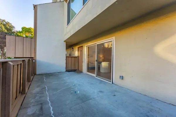 a view of a hallway with wooden fence