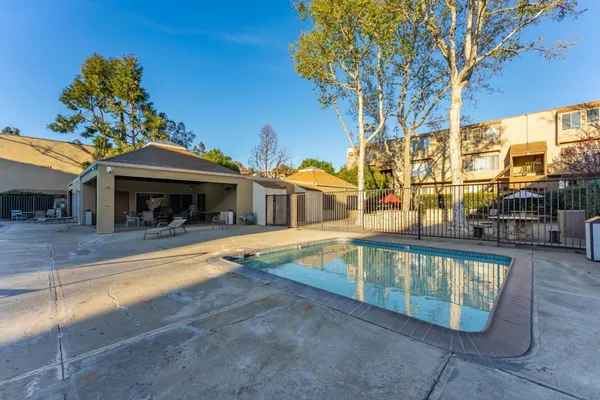 a view of a house with pool and sitting area