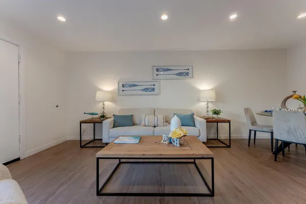 a living room with furniture and wooden floor