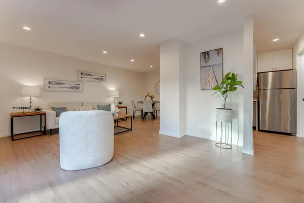a living room with furniture and a wooden floor