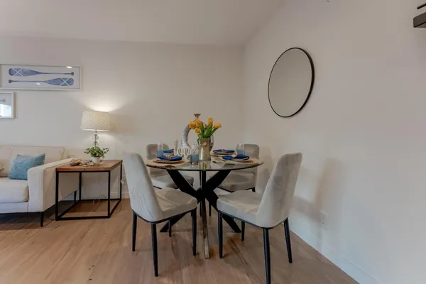 a view of a dining room with furniture and wooden floor