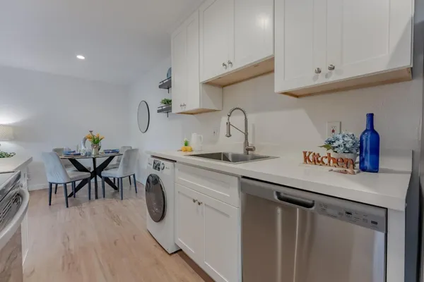 a kitchen with sink and cabinets