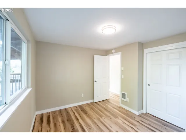 a view of an empty room and wooden floor