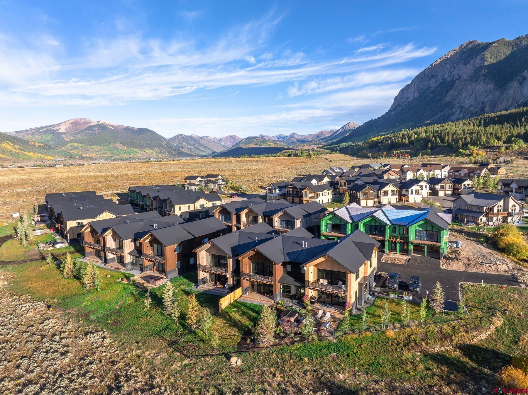 180 Elk Valley Road, Unit 112 Crested Butte, CO 81224 - Photo 17 of 27 a view of a lake with a building in the background