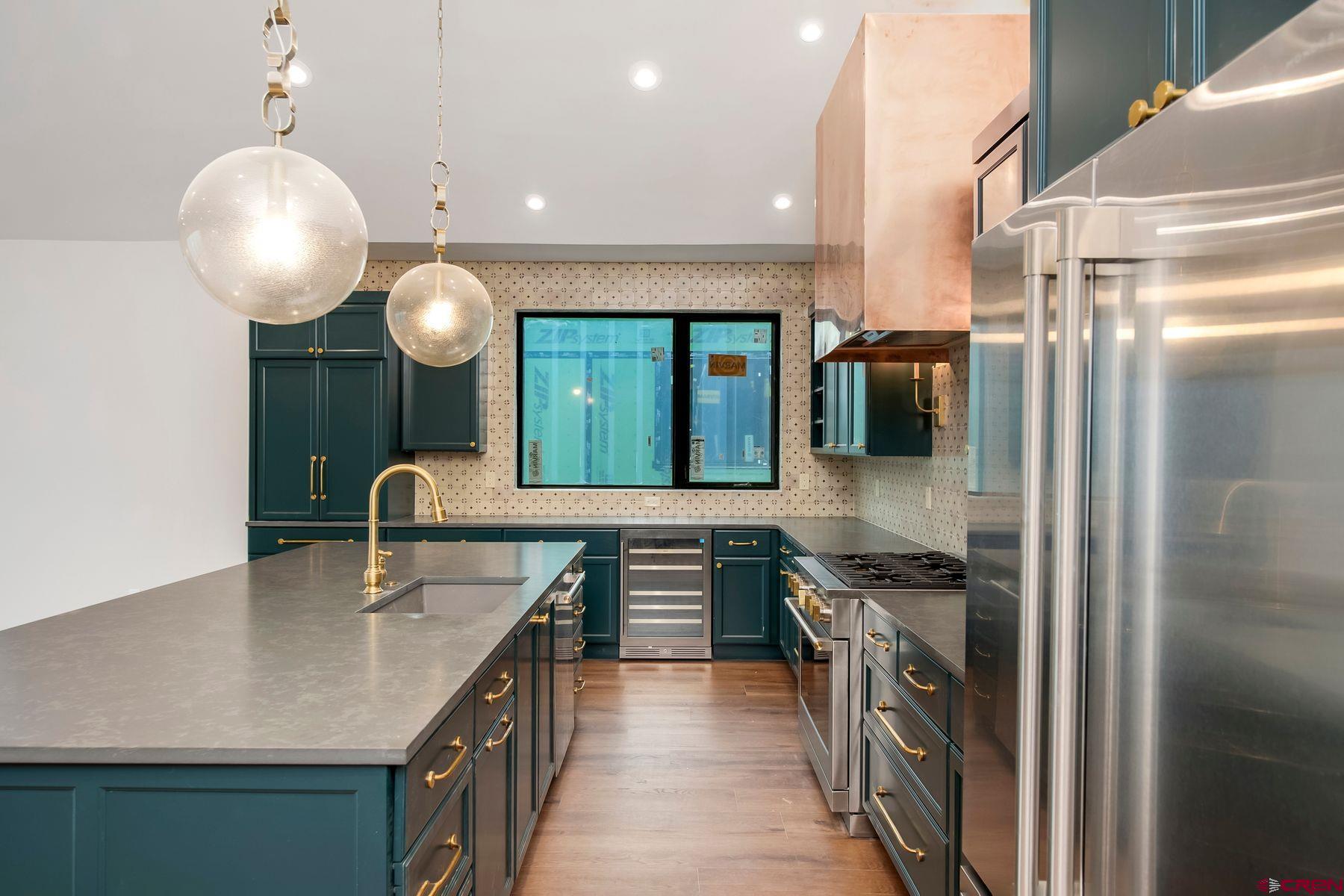 180 Elk Valley Road, Unit 112 Crested Butte, CO 81224 - Photo 7 of 27 a kitchen with stainless steel appliances granite countertop a sink and a stove