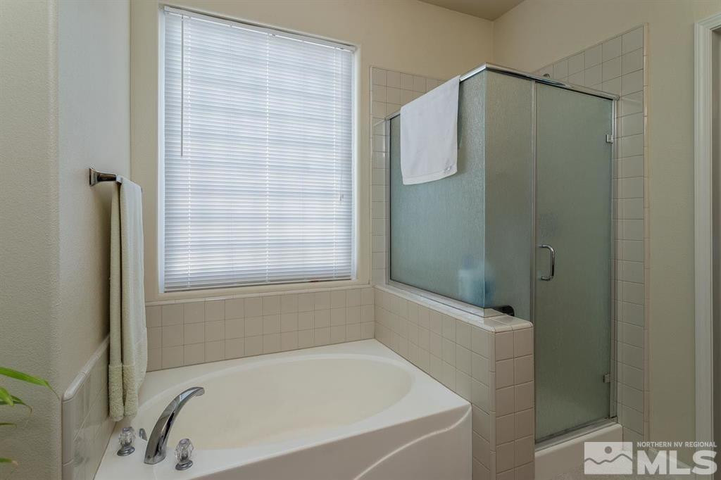 10845 Dancing Aspen Drive Reno, NV 89521 - Photo 7 of 9 a bathroom with a bathtub and a shower