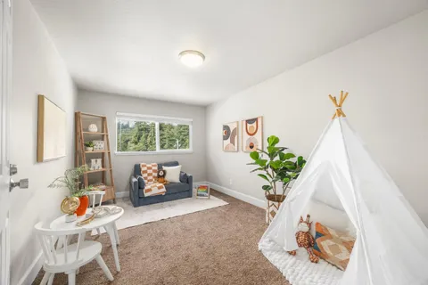 a living room with furniture and a potted plant