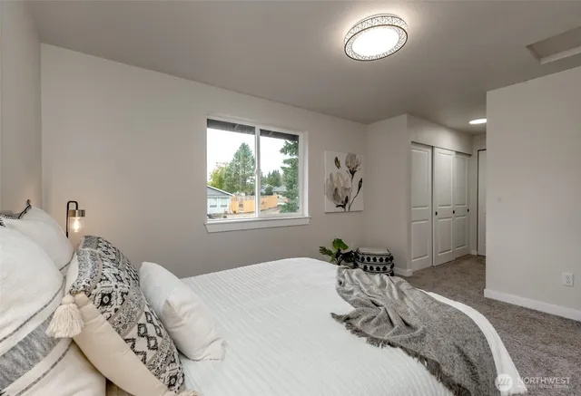 a bedroom with a bed and a window