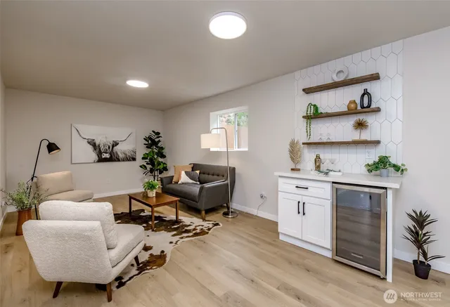 a living room with furniture and wooden floor