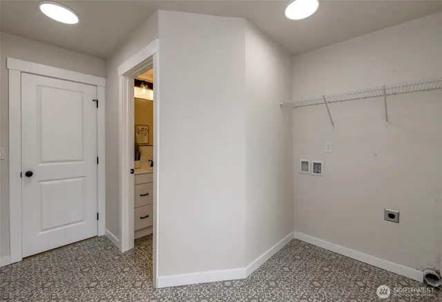 a bathroom with a sink a toilet a glass door a shower and vanity