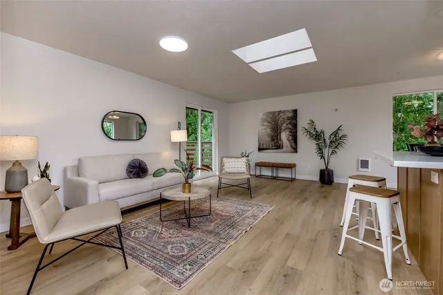 a living room with furniture rug and window