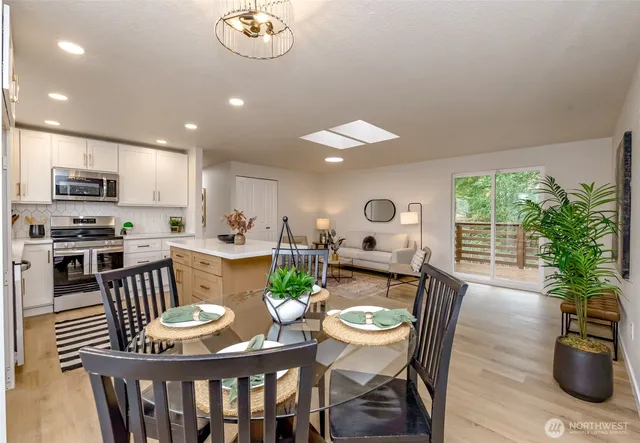 a view of a dining room with furniture window and wooden floor
