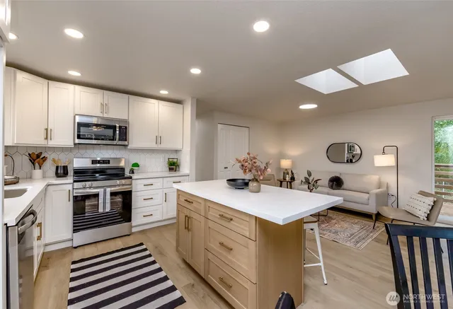 a kitchen with a sink appliances and cabinets