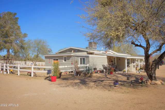 a view of a house with a backyard and a chair