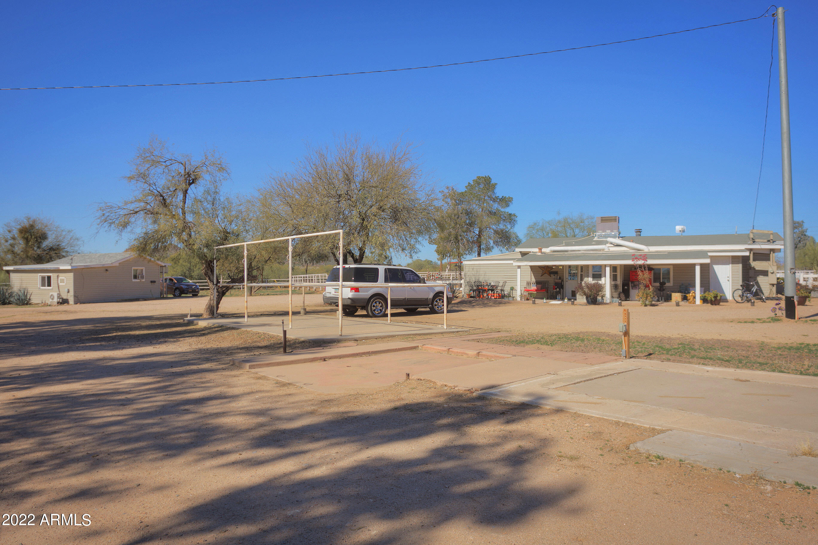 35225 North 3rd Street Phoenix, AZ 85086 - Photo 26 of 40 a view of a white house with a big yard and large trees