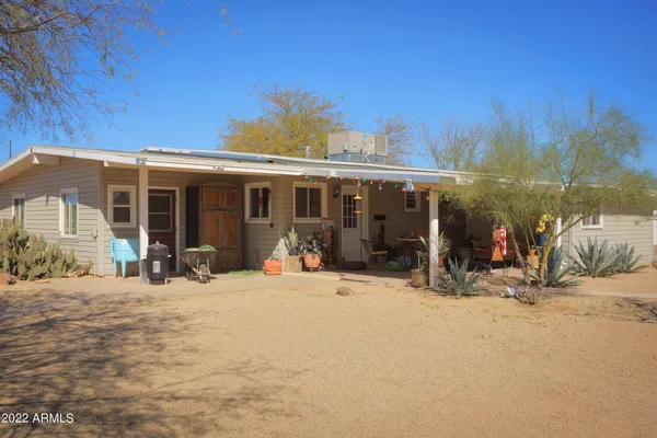 a living room with furniture and a dining table with kitchen view