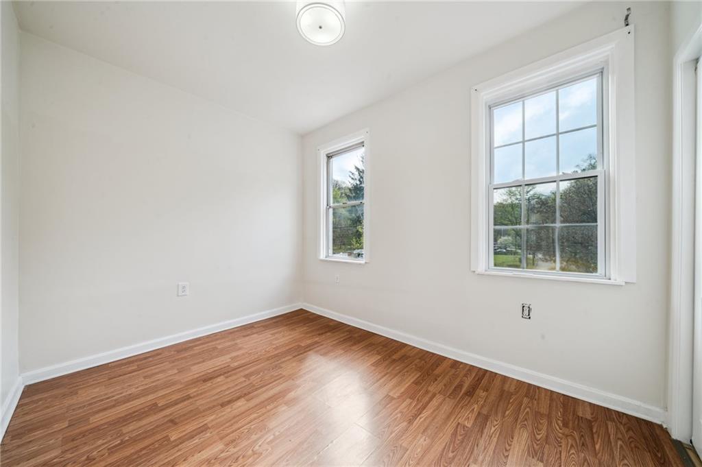 2819 Spring Garden Avenue Pittsburgh, PA 15212 - Photo 12 of 25 an empty room with wooden floor and windows