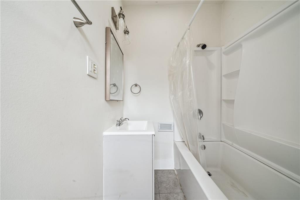 2819 Spring Garden Avenue Pittsburgh, PA 15212 - Photo 14 of 25 a bathroom with a sink a mirror and a bathtub