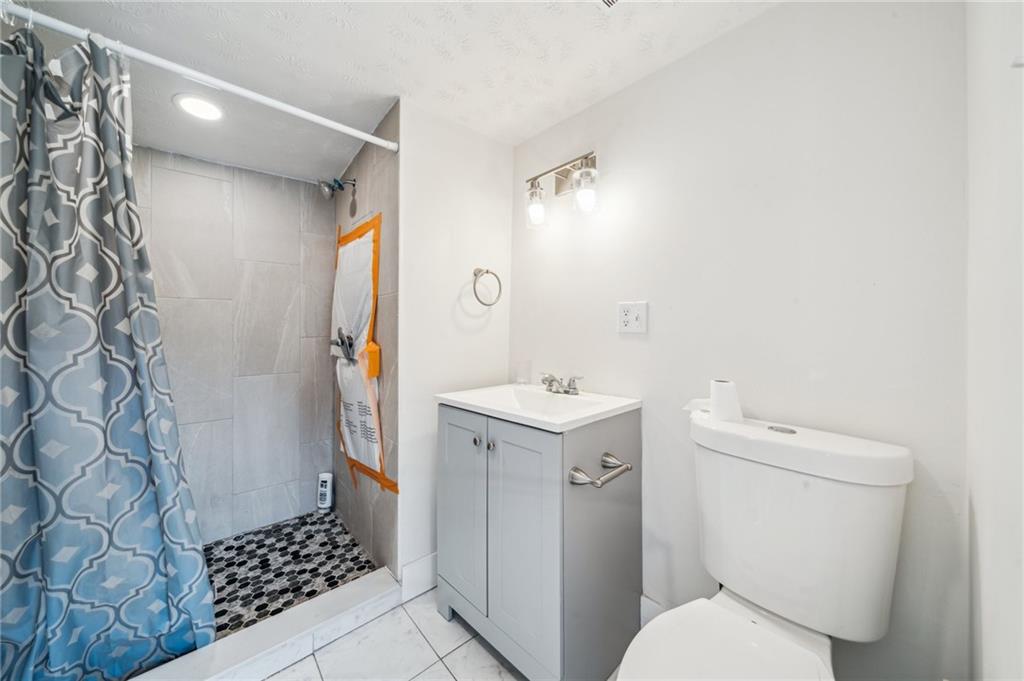 2819 Spring Garden Avenue Pittsburgh, PA 15212 - Photo 15 of 25 a bathroom with a sink toilet and shower