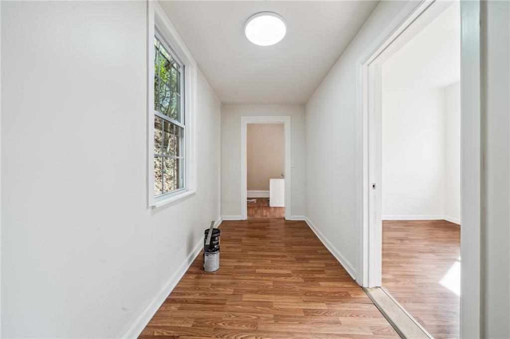 2819 Spring Garden Avenue Pittsburgh, PA 15212 - Photo 16 of 25 a view of a hallway with wooden floor and a bathroom