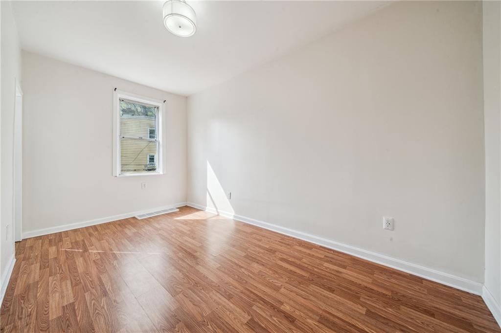 2819 Spring Garden Avenue Pittsburgh, PA 15212 - Photo 19 of 25 an empty room with wooden floor and windows