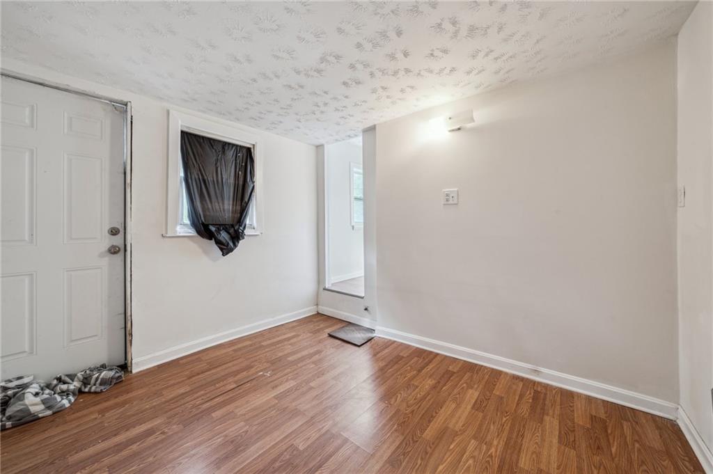 2819 Spring Garden Avenue Pittsburgh, PA 15212 - Photo 21 of 25 a view of a livingroom with wooden floor and a flat screen tv