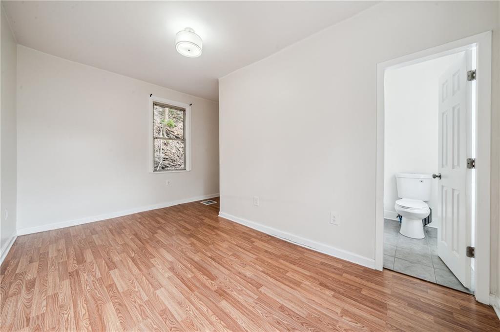 2819 Spring Garden Avenue Pittsburgh, PA 15212 - Photo 3 of 25 a view of a room with wooden floor and a toilet