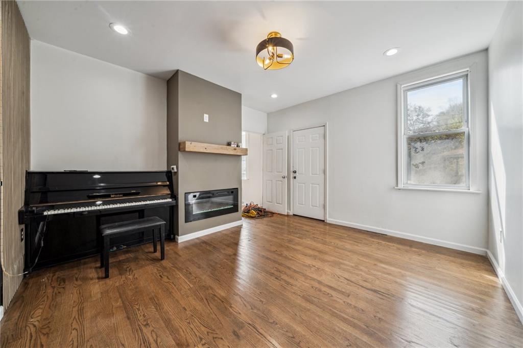 2819 Spring Garden Avenue Pittsburgh, PA 15212 - Photo 5 of 25 a view of an empty room with a window and wooden floor