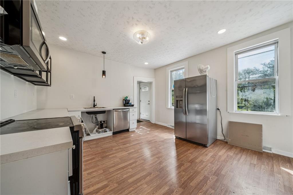 2819 Spring Garden Avenue Pittsburgh, PA 15212 - Photo 10 of 25 a kitchen with stainless steel appliances a refrigerator and a stove top oven