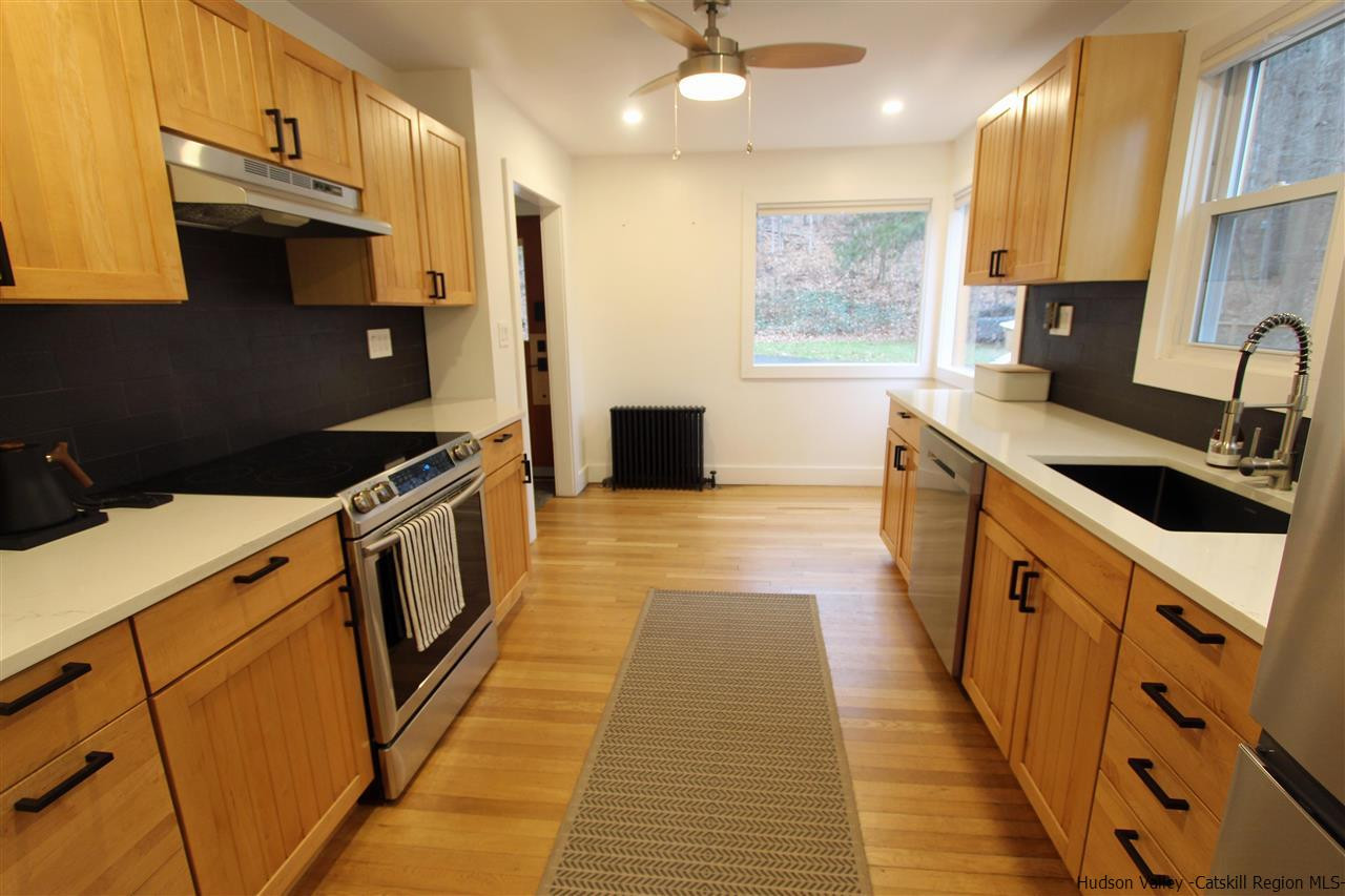 30-32 Rudy Frank Road Shandaken, NY 12480 - Photo 15 of 35 a kitchen with kitchen island granite countertop a sink and a stove top oven
