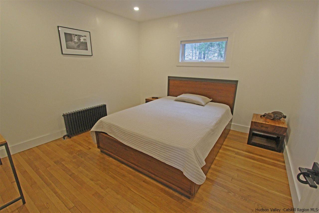 30-32 Rudy Frank Road Shandaken, NY 12480 - Photo 22 of 35 a bedroom with a bed and wooden floor