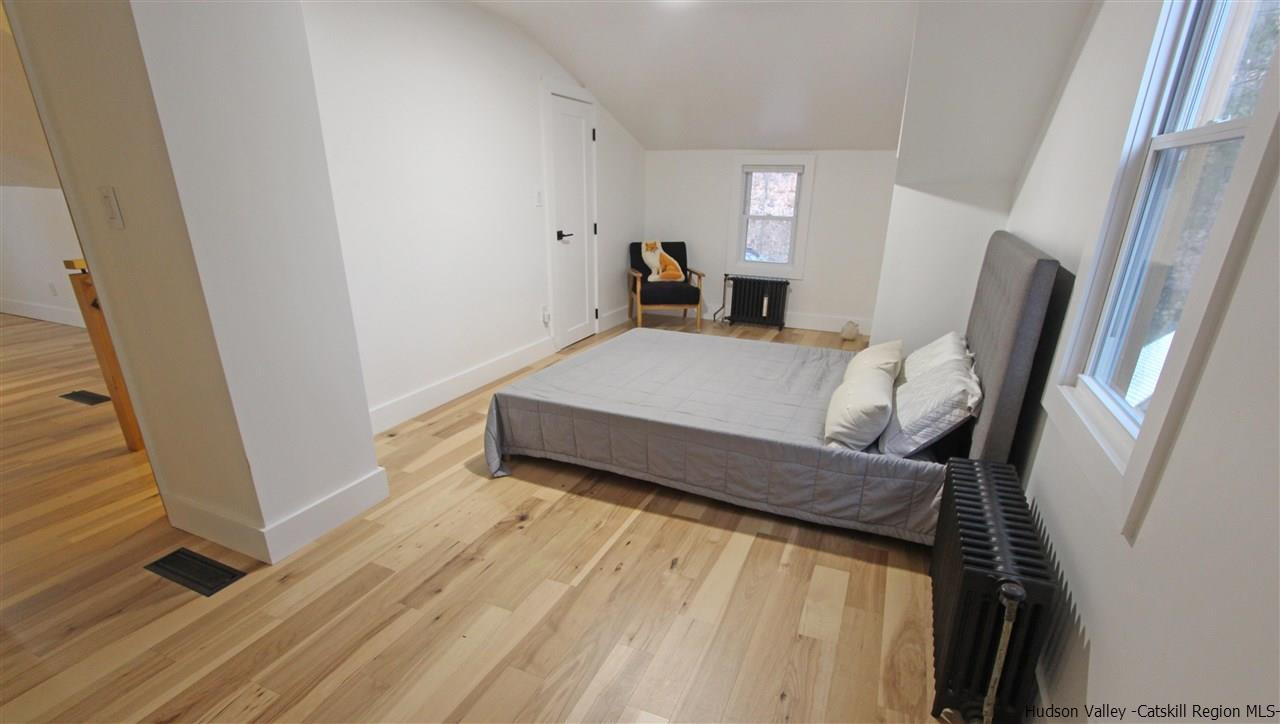 30-32 Rudy Frank Road Shandaken, NY 12480 - Photo 27 of 35 a bedroom with a bed and wooden floor