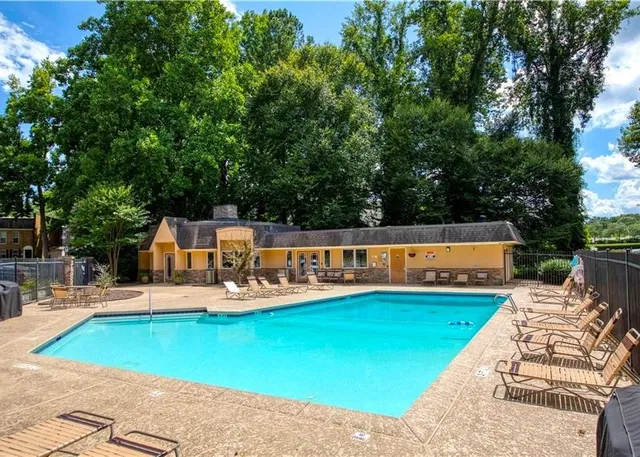 swimming pool view with a seating space
