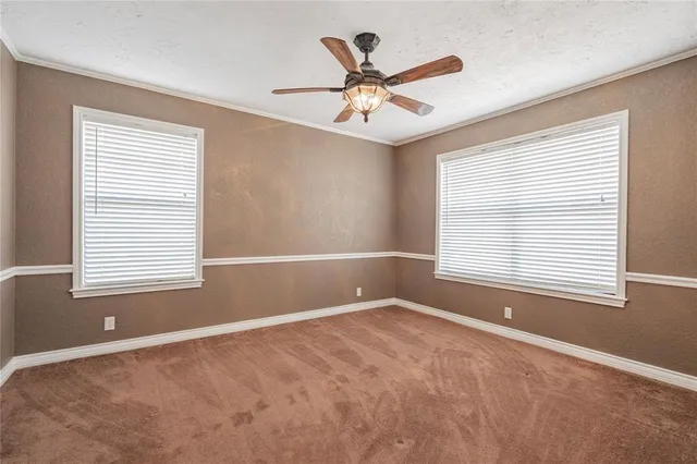 a view of a livingroom with a ceiling fan and window