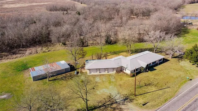an aerial view of a house with swimming pool garden and patio