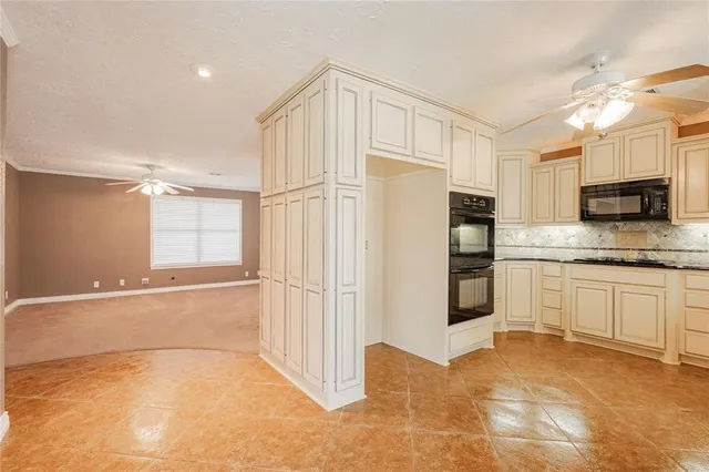 a kitchen with stainless steel appliances a refrigerator and a stove top oven
